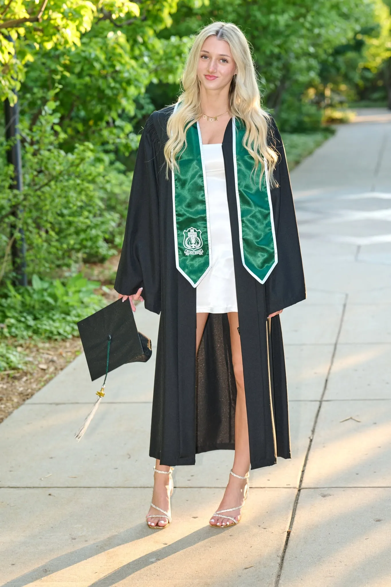 A graduate in cap and gown captured mid stride, a moment of motion