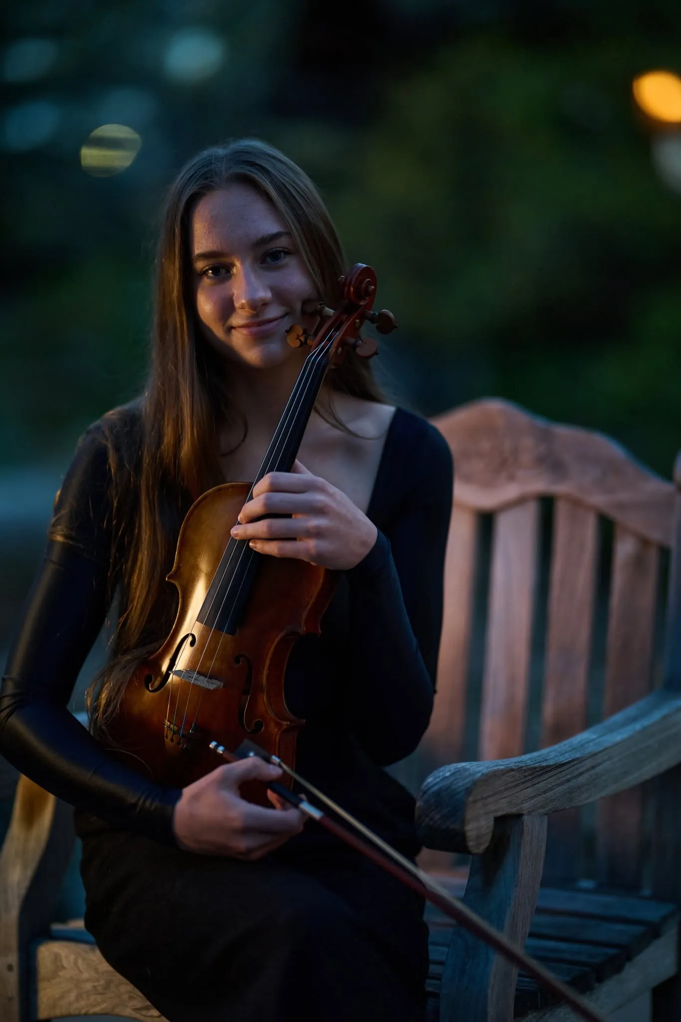 Close portrait of a violinist in warm light, calm and still