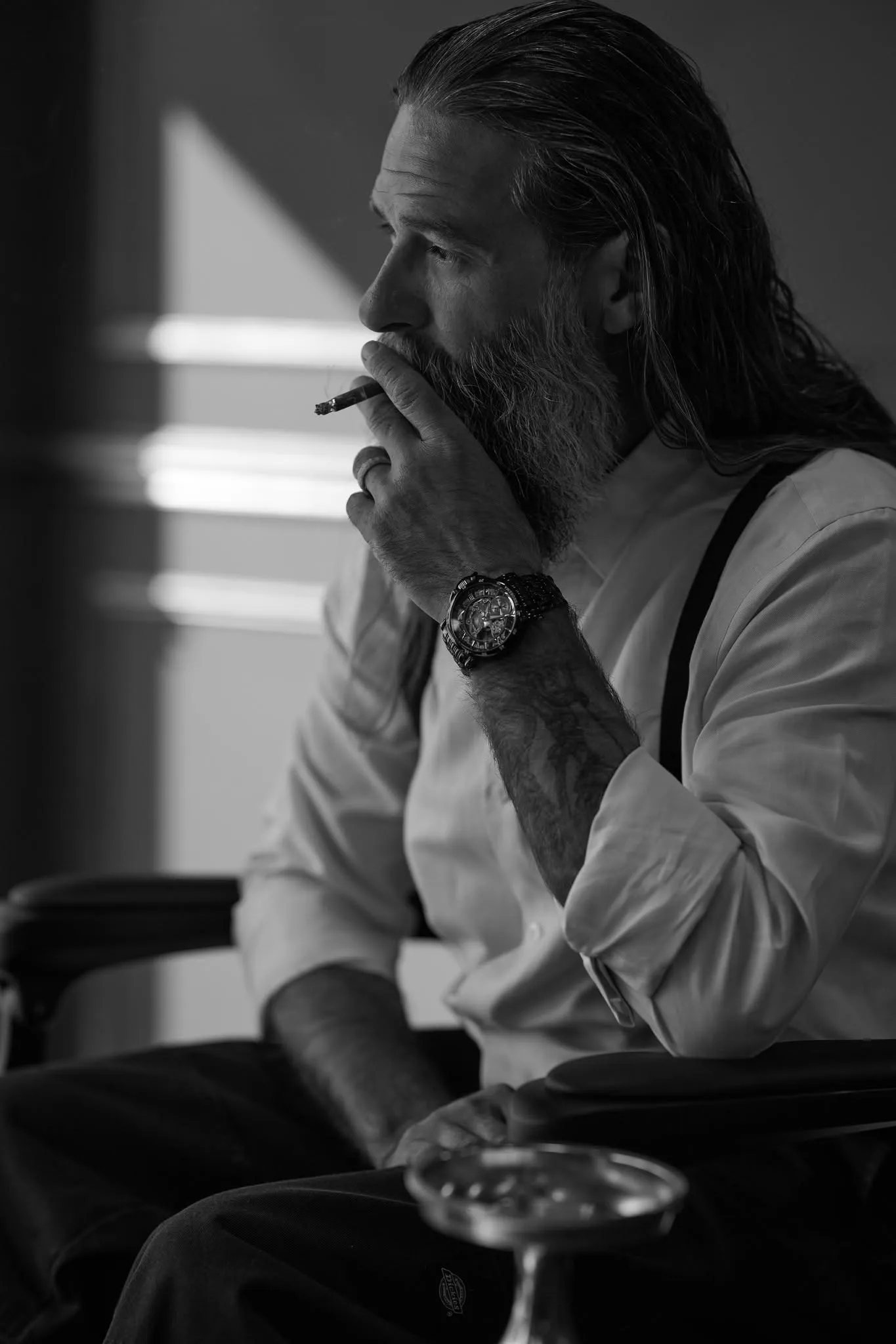 A man in sunglasses with a cigar, black and white