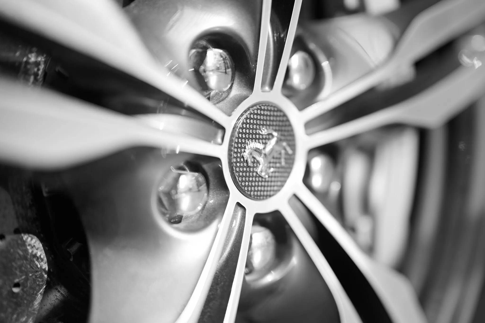 Black and white detail of a Ferrari wheel