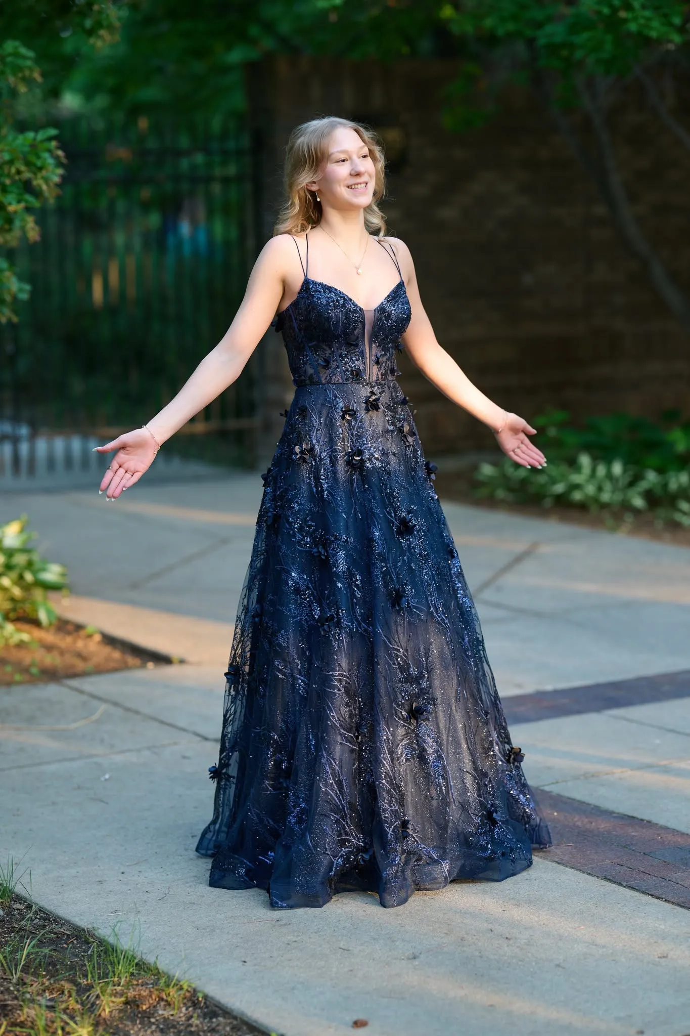 Woman in an evening gown on a garden road
