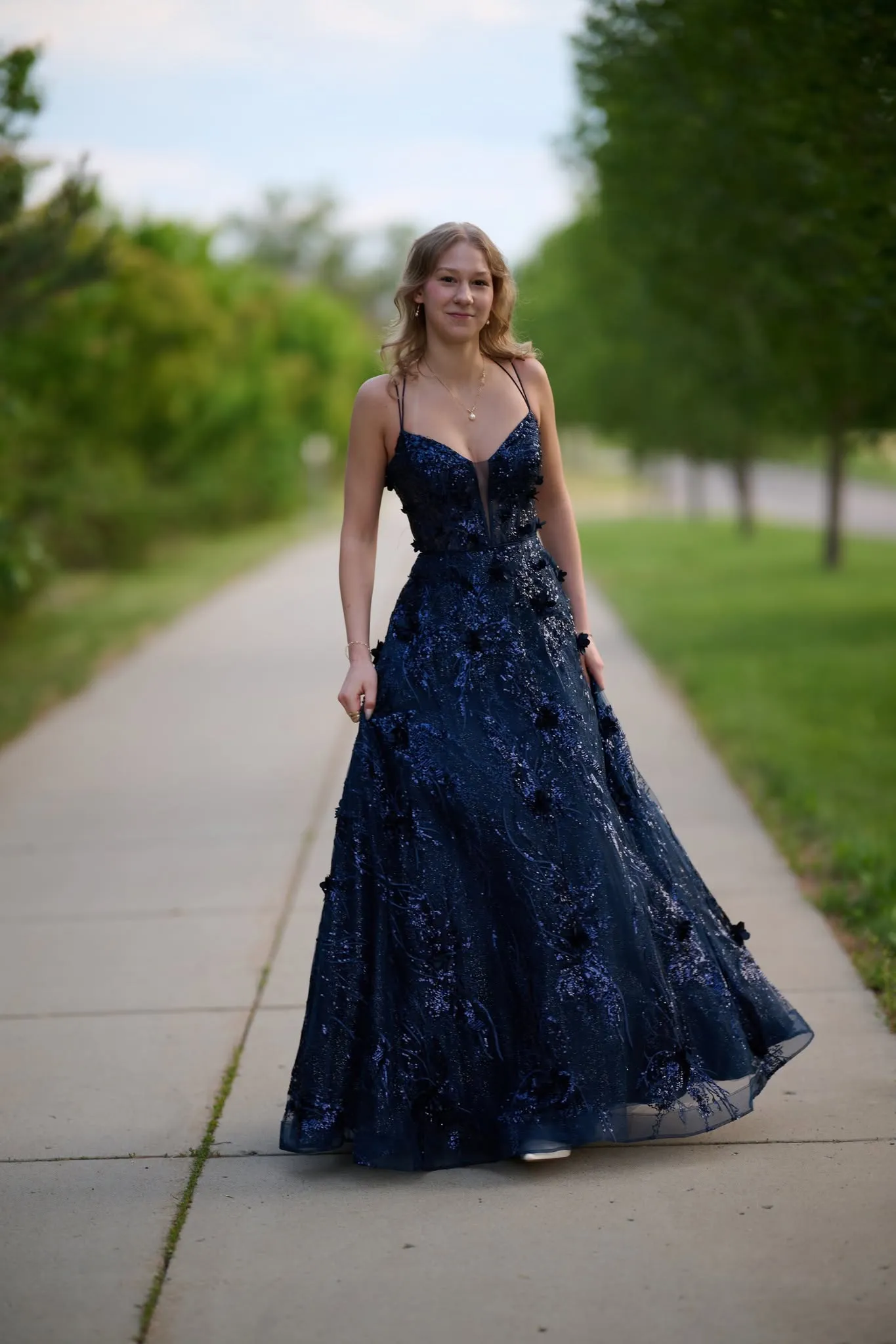 Graduate walking a garden path