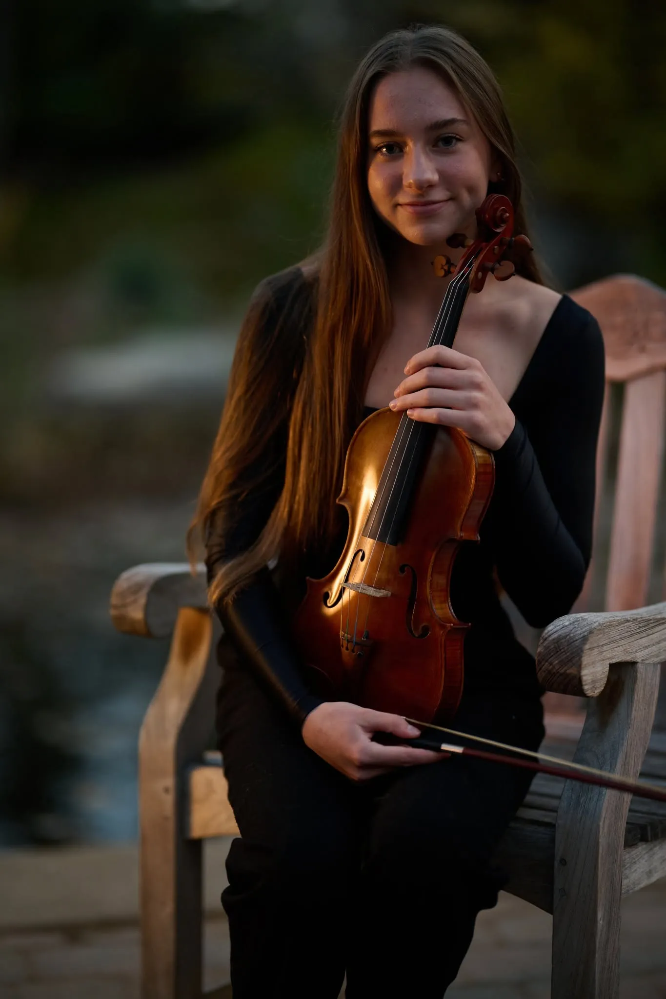 Violinist standing among autumn foliage